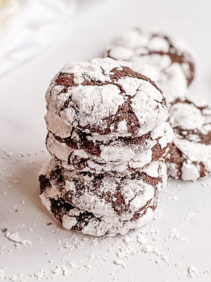 A single stack of gluten-free chocolate crinkle cookies stacked tall.