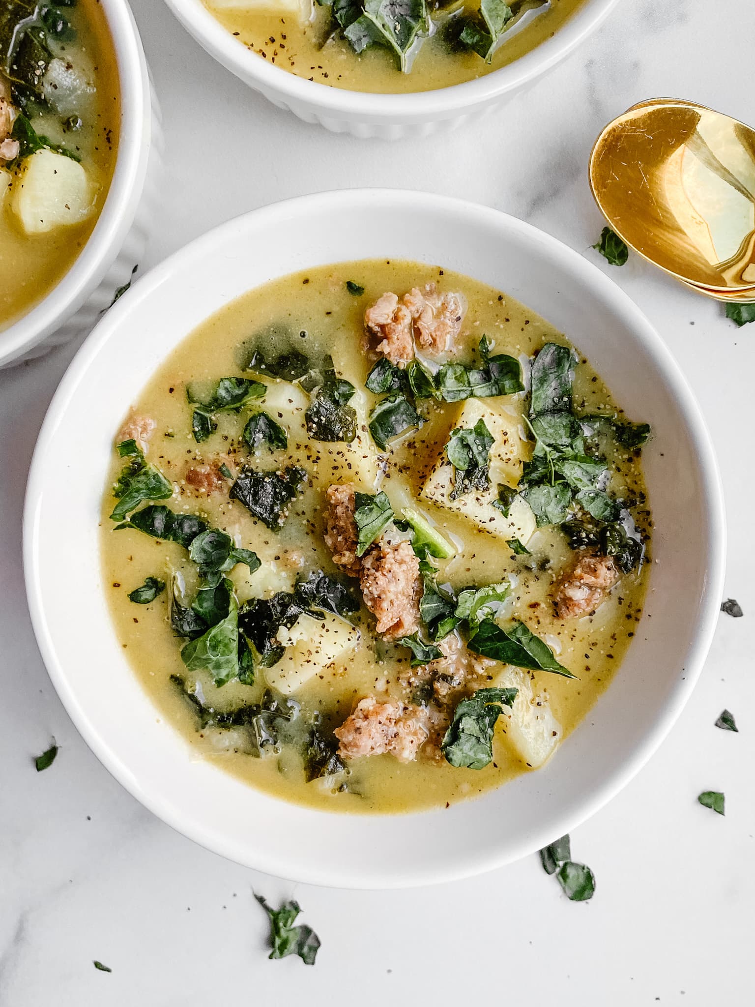 zuppa toscana with large chunks of spicy sausage, white sweet potatoes, and kale.