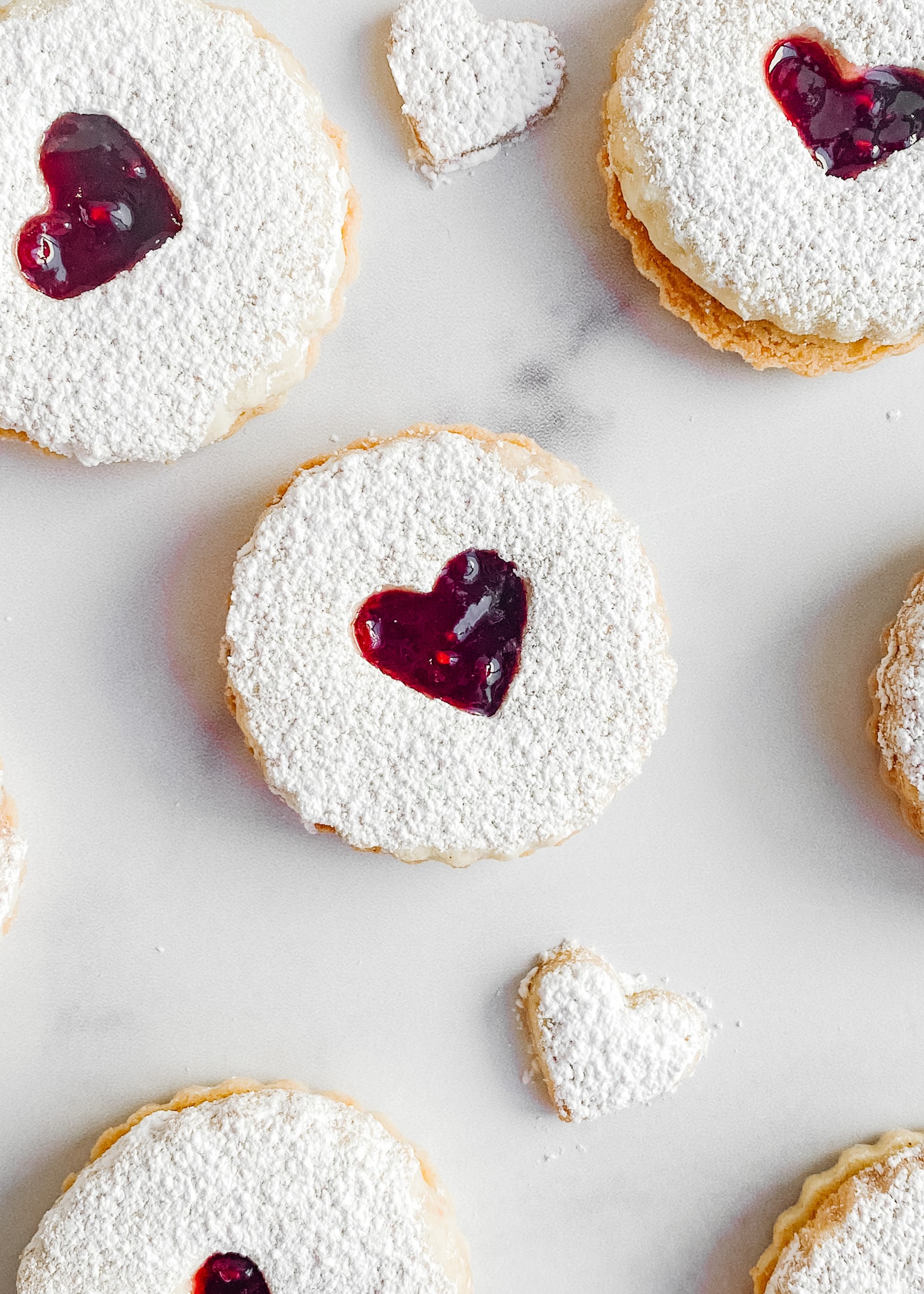 A photo focusing on one gluten-free raspberry linzer cookie.