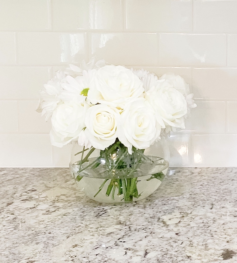 white gloss backsplash and flowers