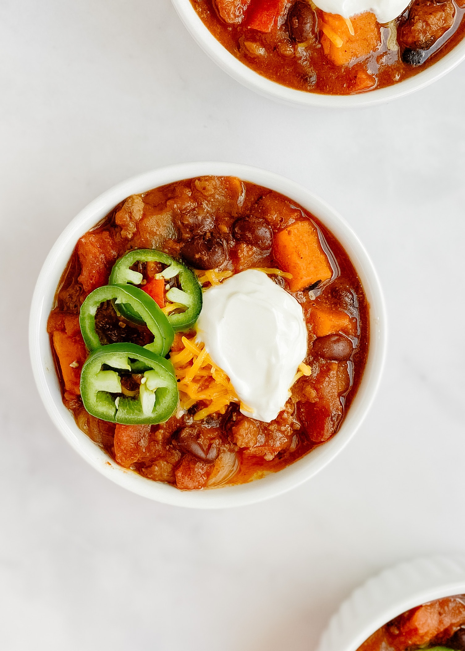 chili with jalapeños and sour cream offset image