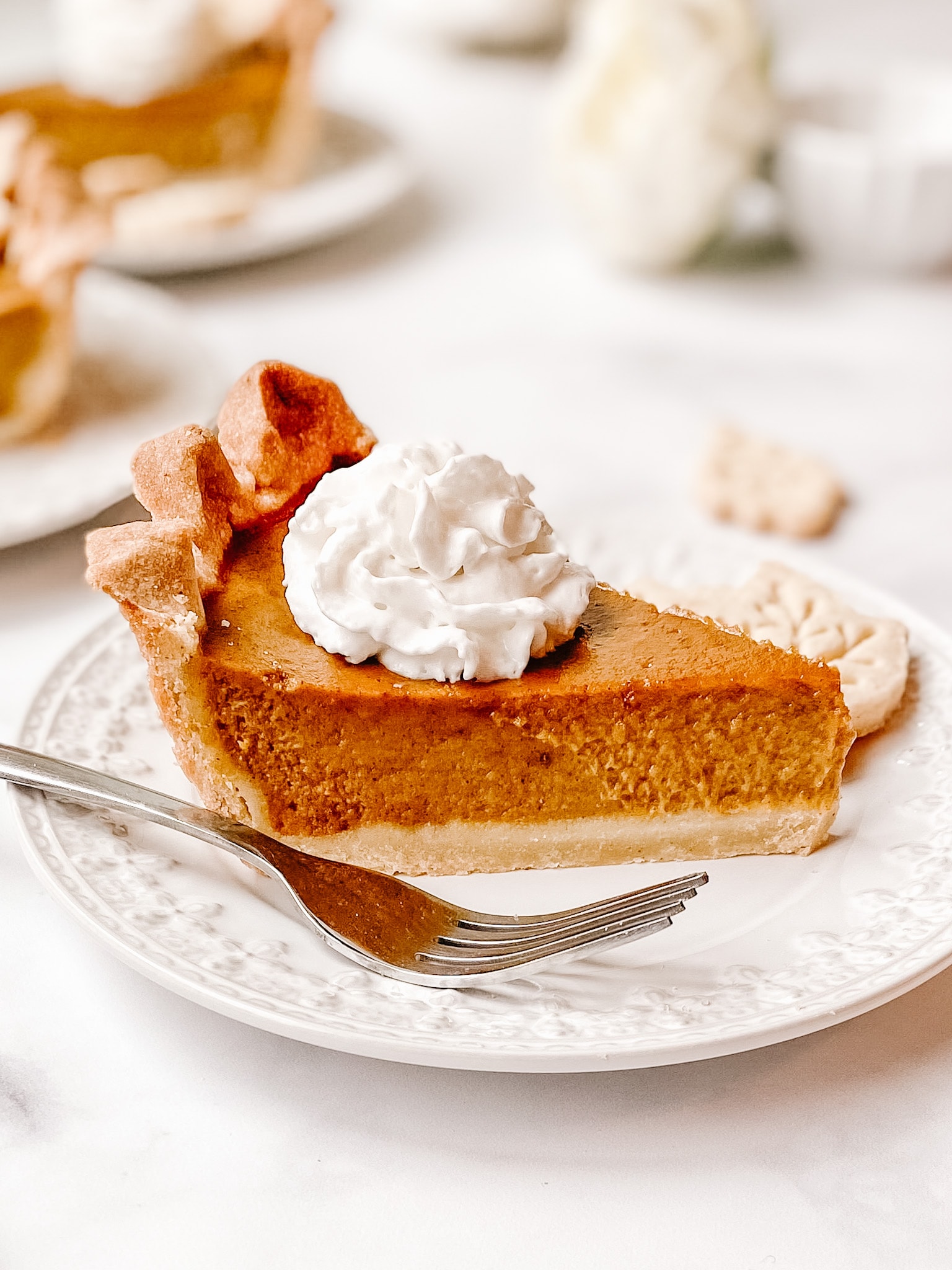 gluten free pumpkin pie slice with whipped cream