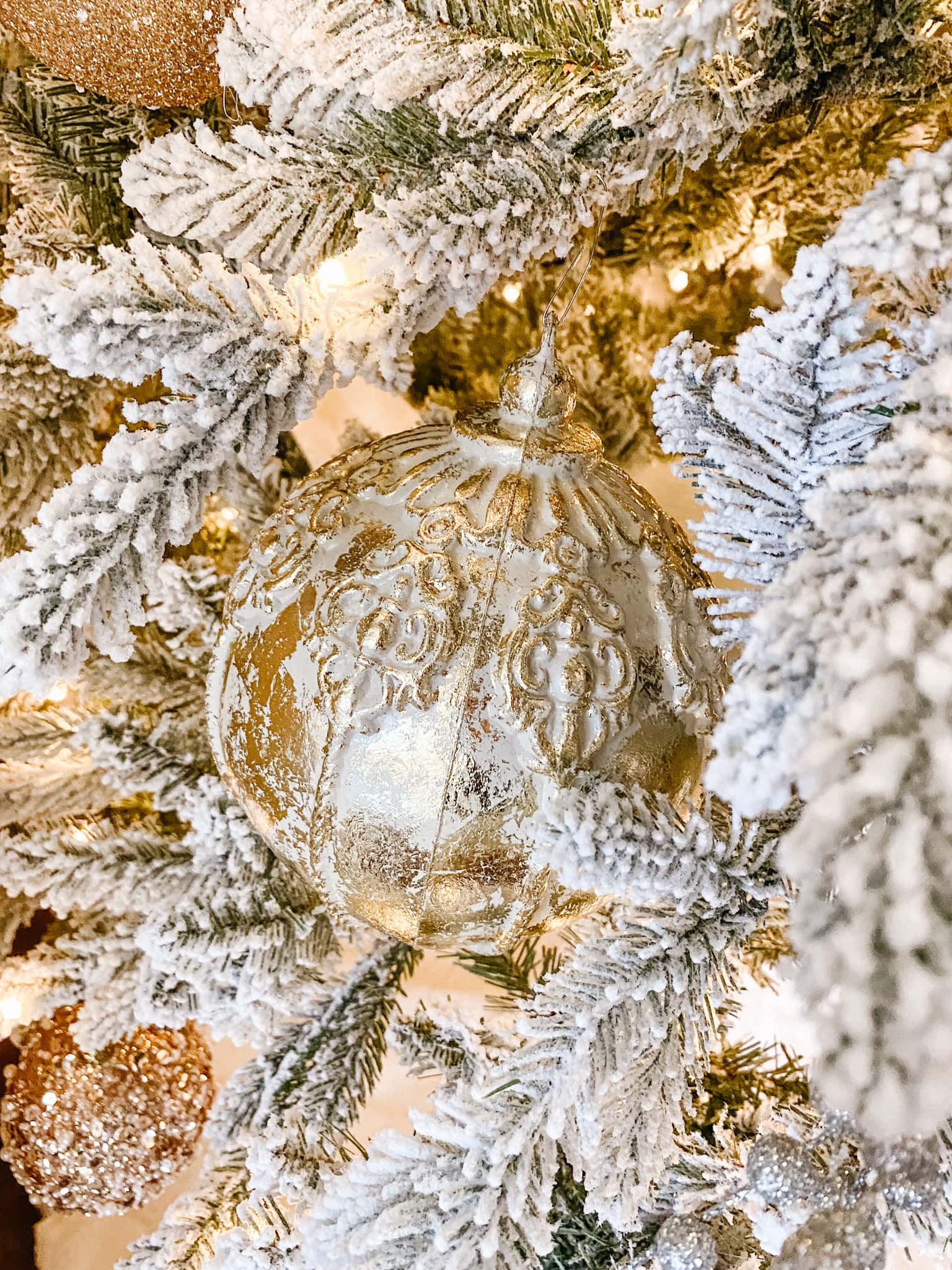 white and gold 12 foot Christmas tree close up of antique bulb