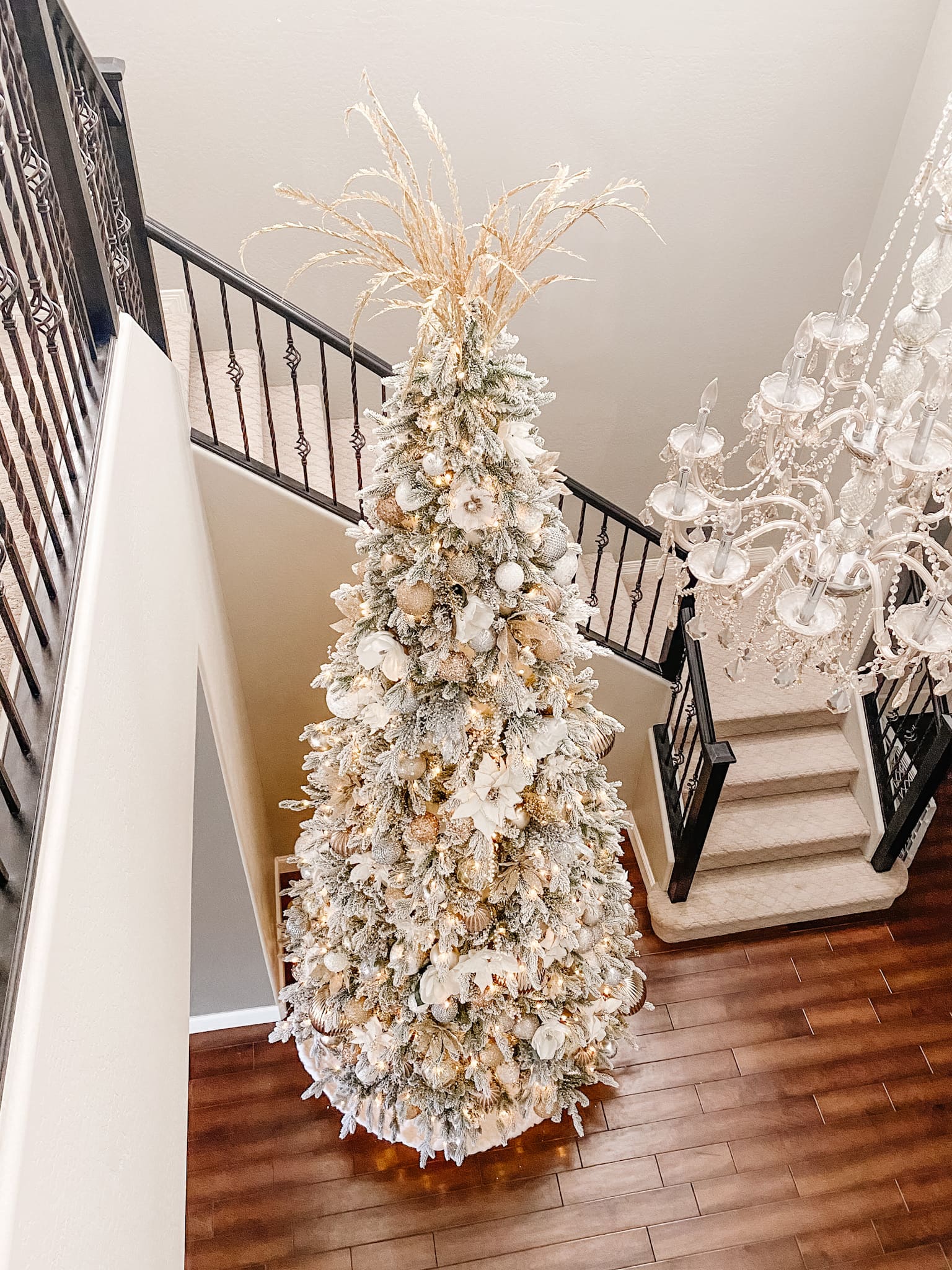 white and gold 12 foot Christmas tree in foyer looking down on tree view