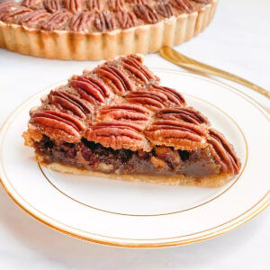 Photo of the gluten-free pecan pie on a white and gold plate.