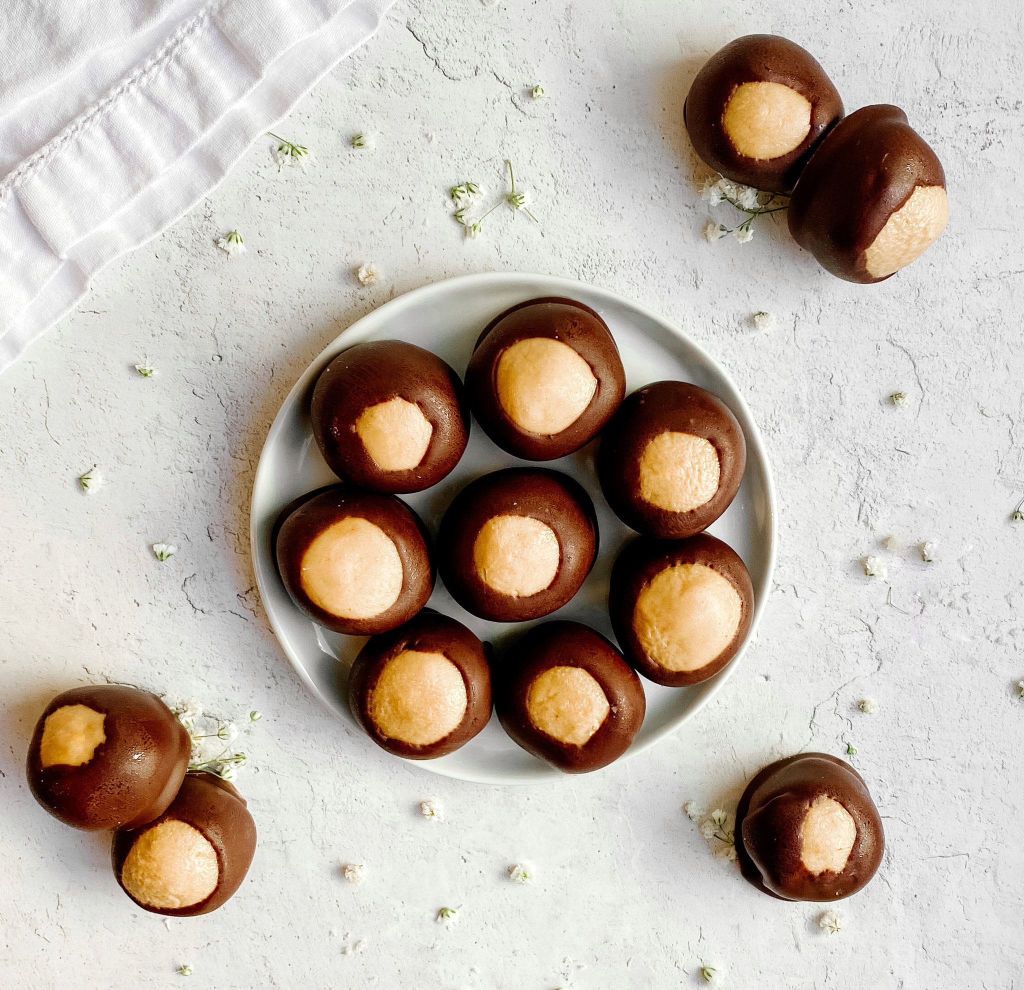 Peanut butter buckeyes on a small ceramic plate.