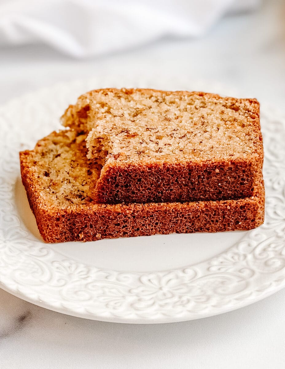 Gluten-Free Banana Bread, two slices stacked on a white ceramic plate.