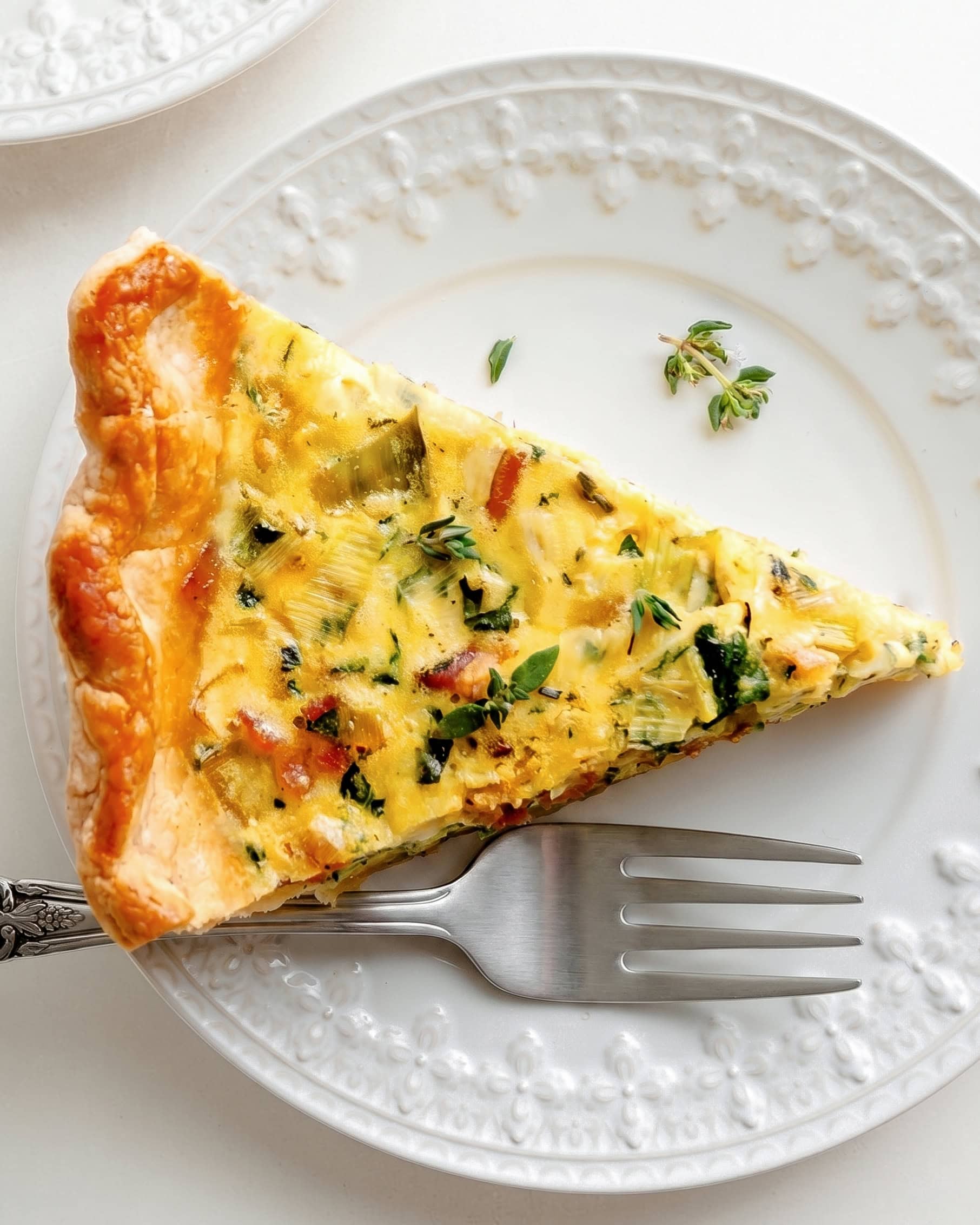 Overhead shot of gluten free spinach quiche with bacon and thyme.