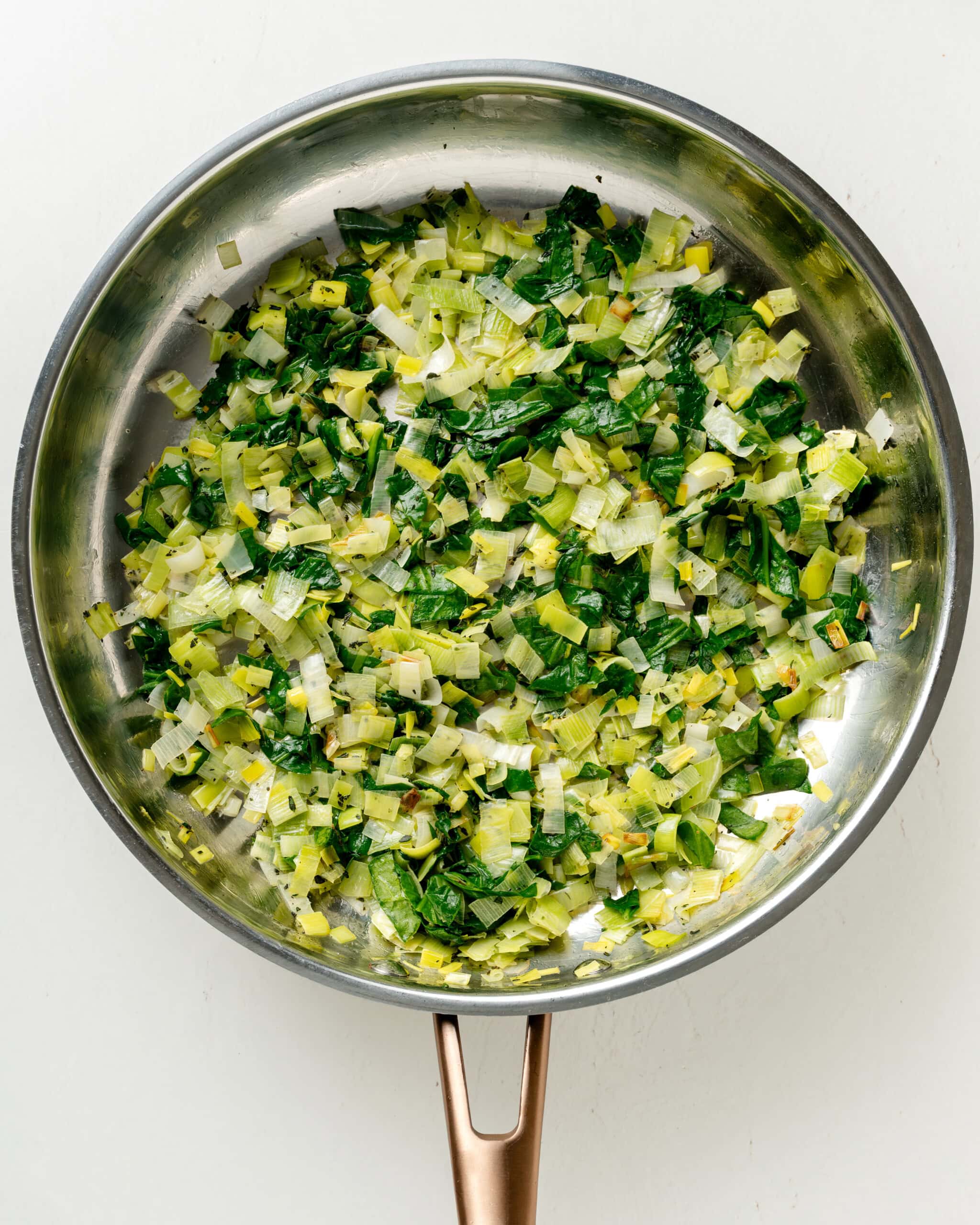 Leeks, spinach, and thyme, in a large skillet.