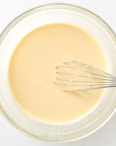 Whisk the eggs, sour cream, and heavy cream together in a large clear bowl.