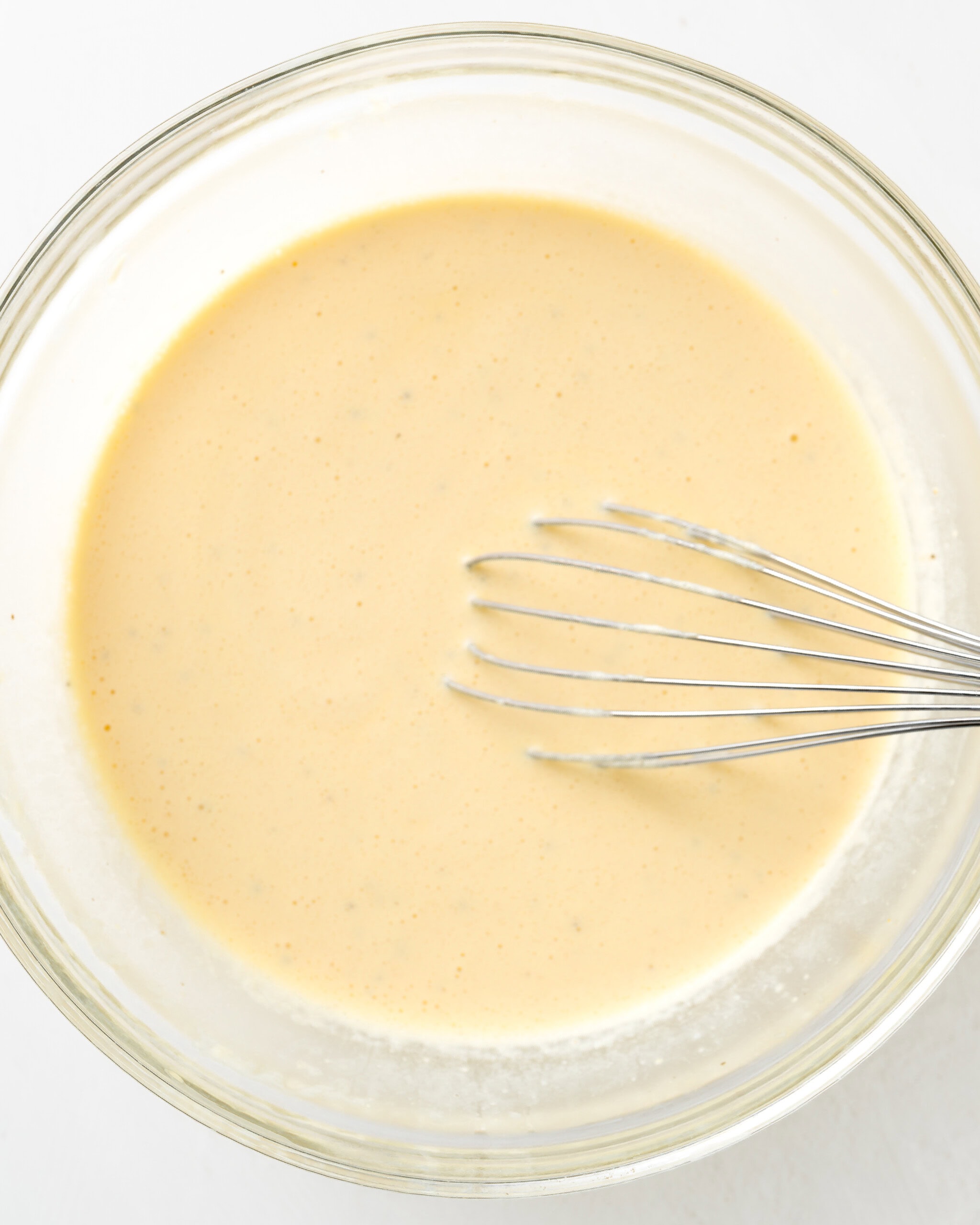 Whisk the eggs, sour cream, and heavy cream together in a large clear bowl.