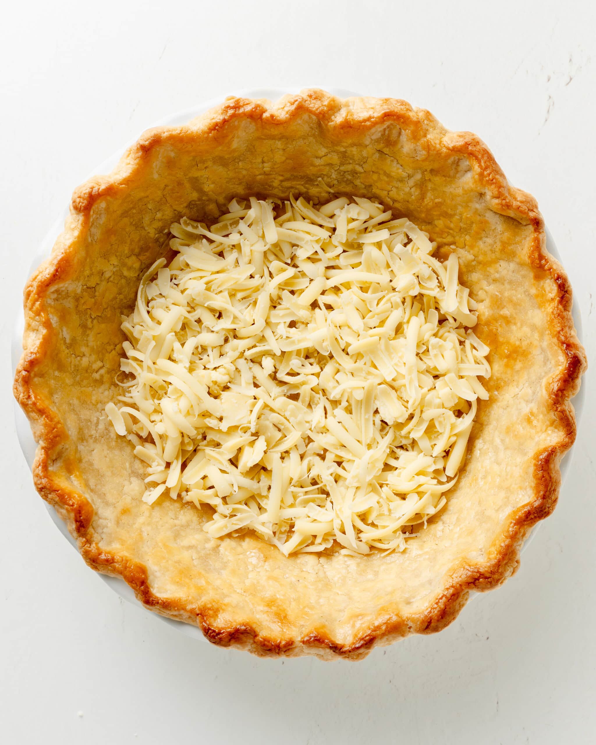 Cheese added to the bottom of pie crust.