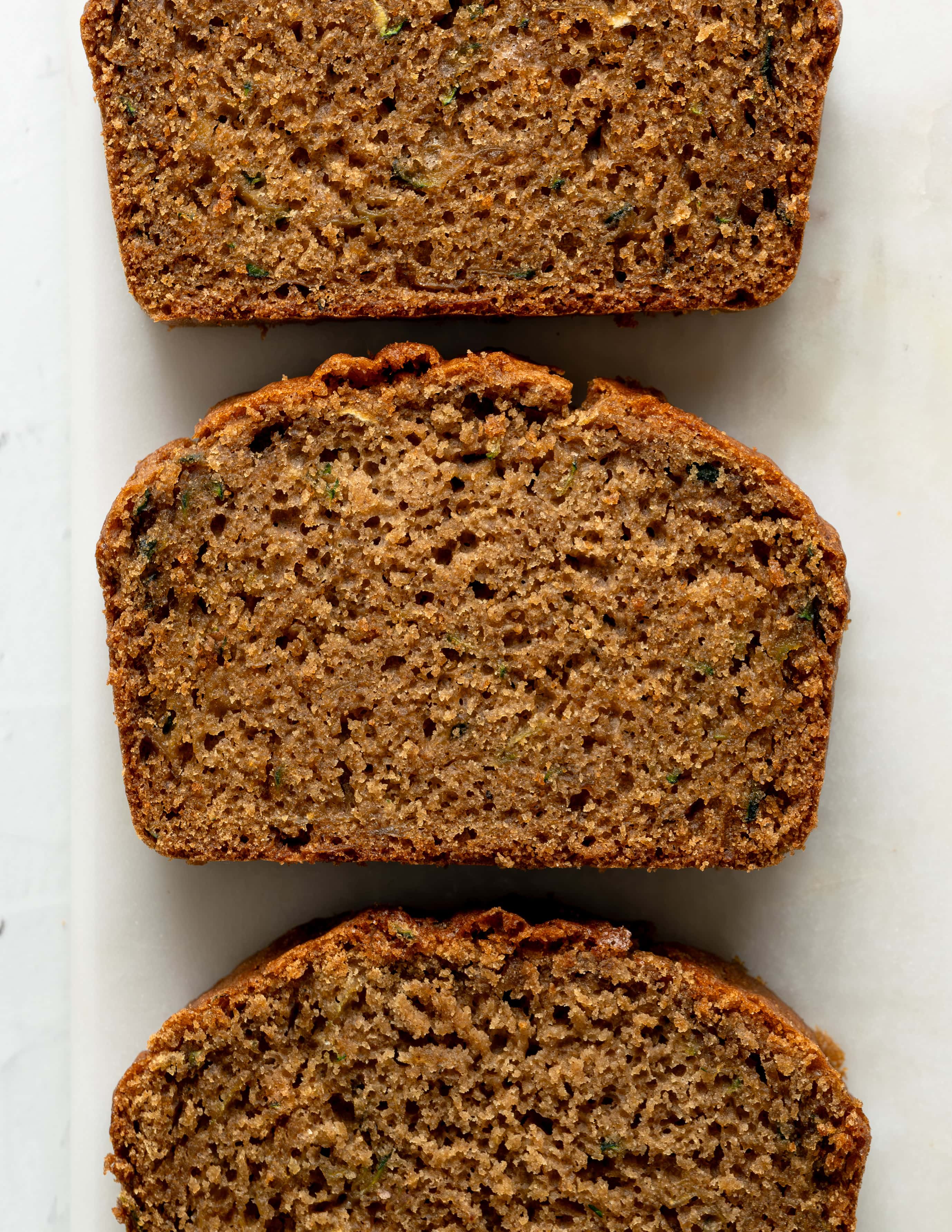 Overview Shot of gluten-free zucchini bread sliced into three sections.