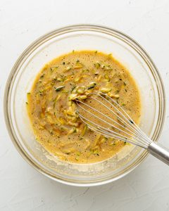 Whisking together the wet ingredients for gluten free zucchini bread.