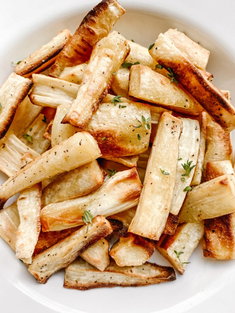 A close-up shot of roasted parsnips in a bowl. 