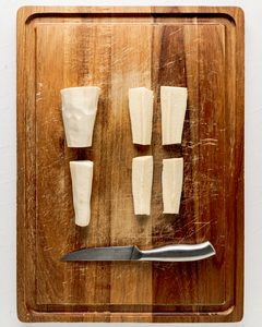 Slice the parsnips in half and then into quarters.