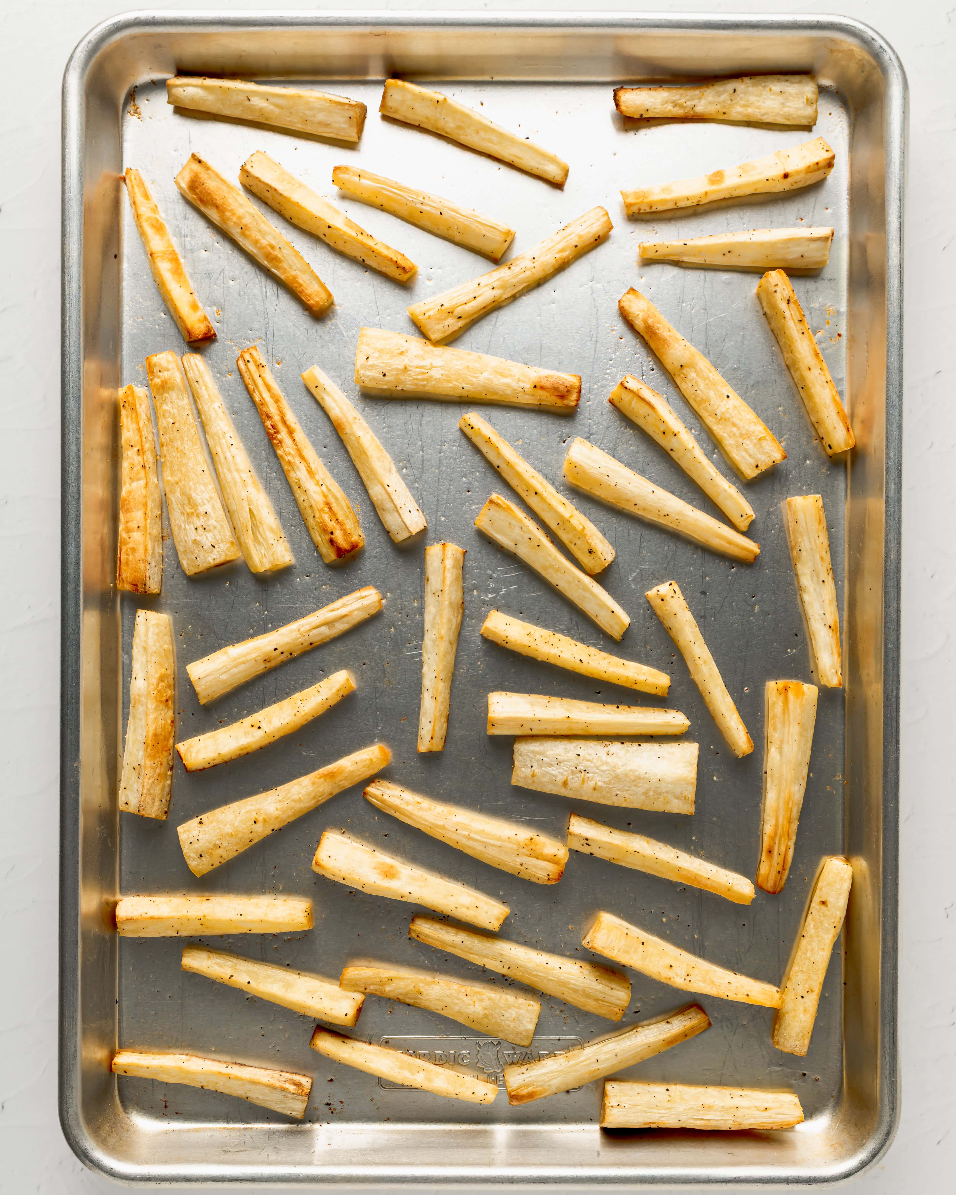 Roast the parsnips until golden brown on the unlined baking sheet.