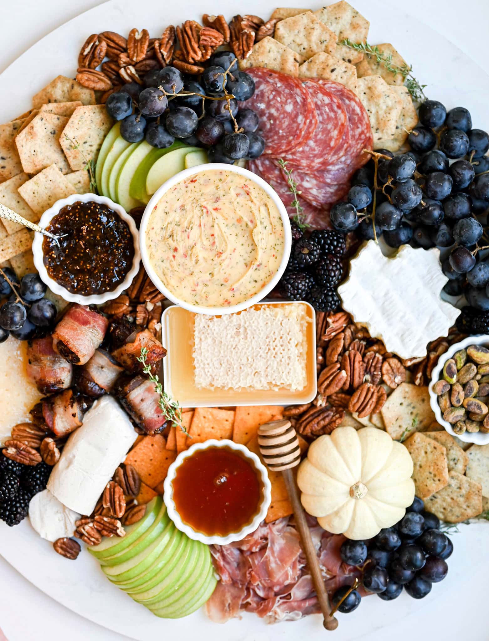 gluten-free fall Charcuterie board. Various meats, cheese, crackers, dips, fruits, and nuts can be seen.