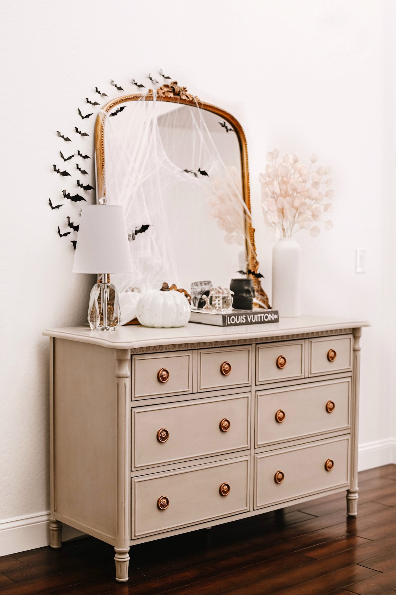 foyer chest with a gold mirror and Halloween home tour decorations