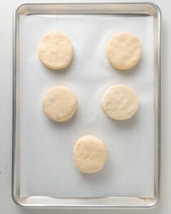 Brush the tops of the biscuits with buttermilk then bake.