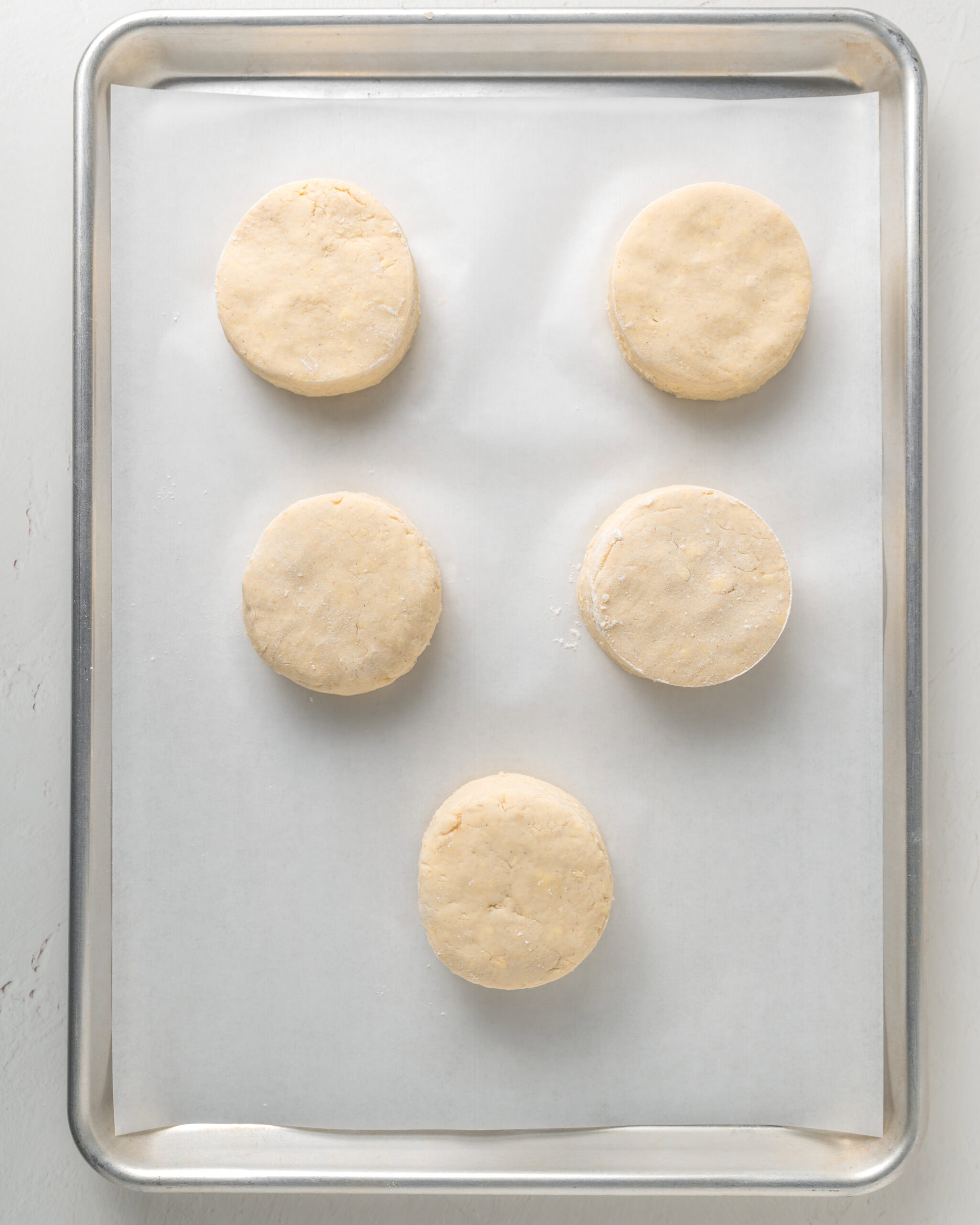 Brush the tops of the biscuits with buttermilk then bake.