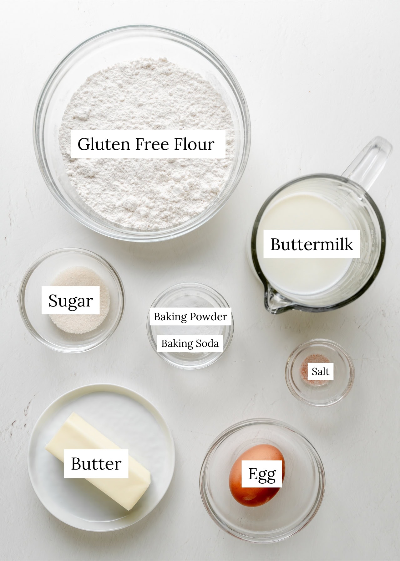 Buttermilk biscuit ingredients. Flour, buttermilk, sugar baking soda, baking powder, salt, butter, egg.