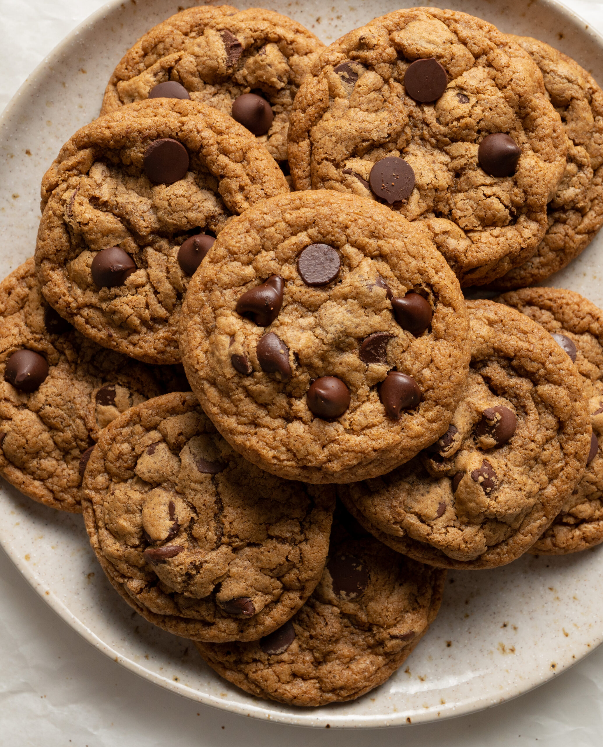 An aerial view of a plate of pumpkin chocolate chip cookies.