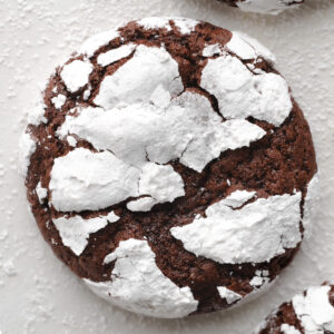An enlarged photo of a chocolate crinkle cookie.