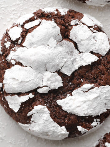 An enlarged photo of a chocolate crinkle cookie.