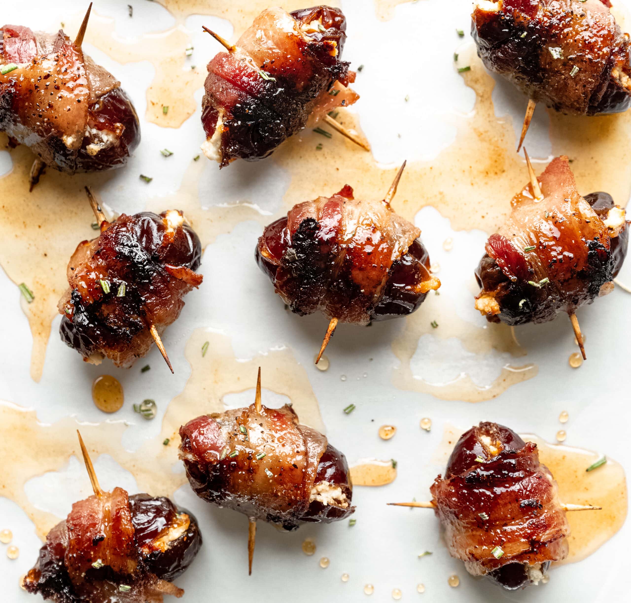 Picture of bacon wrapped dates stuffed with goat cheese and drizzles with honey.