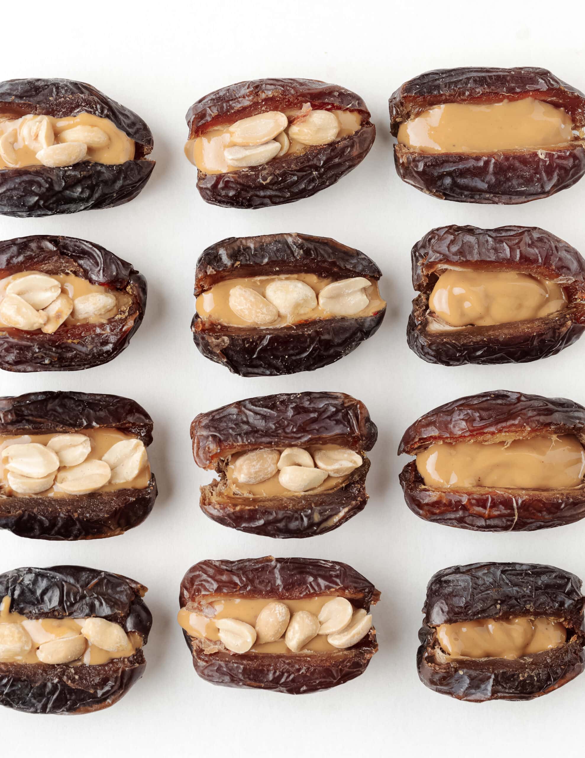Dates that are split open stuffed with peanut butter and choppe peanuts,
