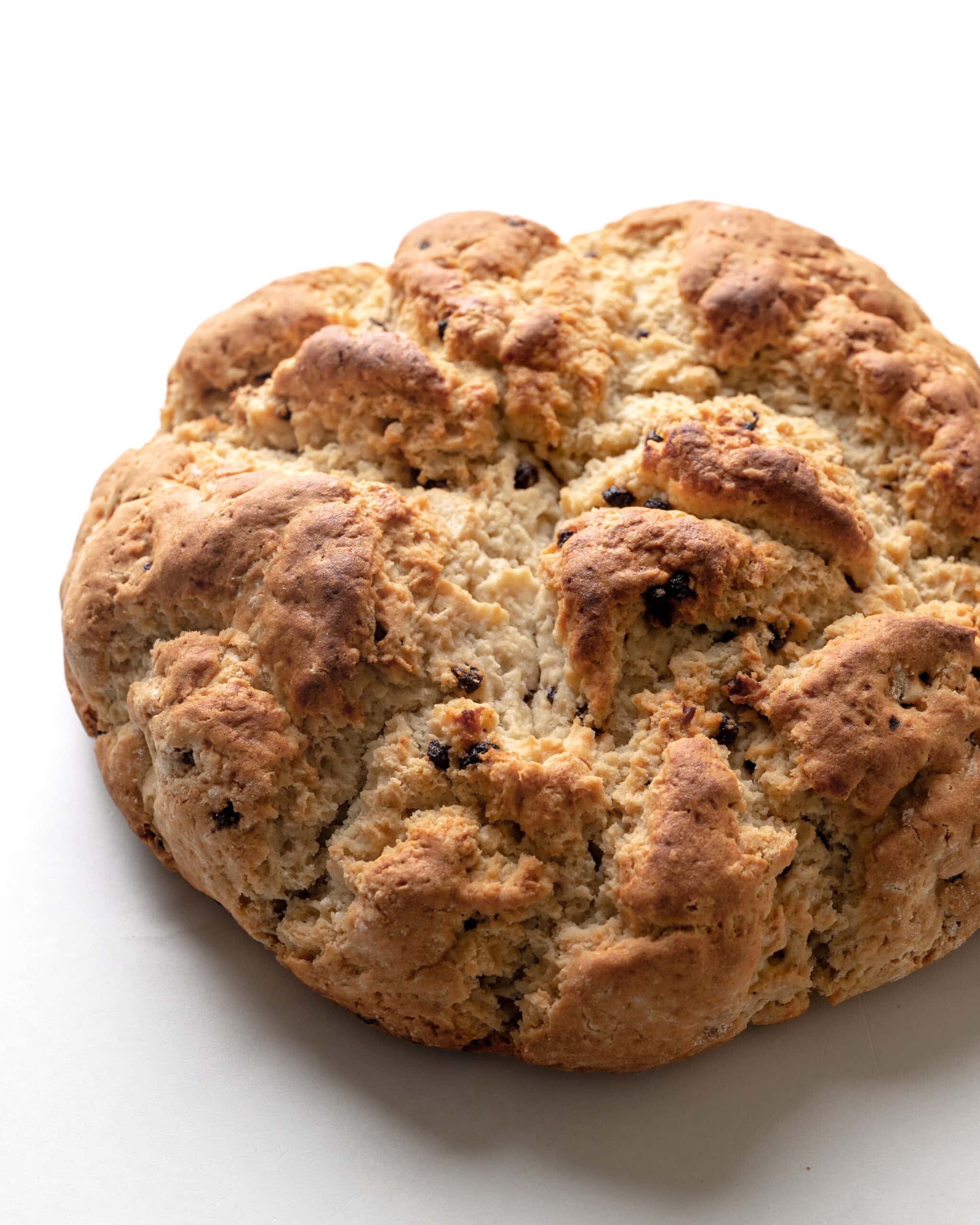 A large picture of gluten-free irish soda bread with currants. 