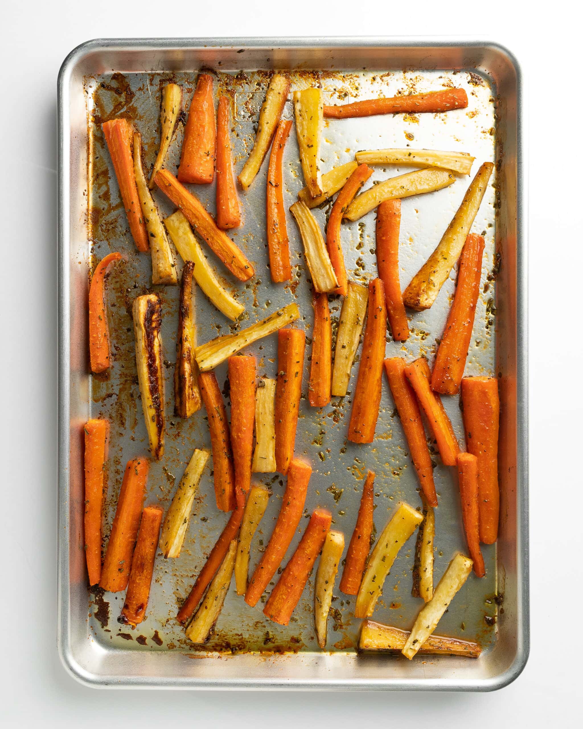 A large baking sheet with roasted carrots and parsnips, carmelized to perfection. 