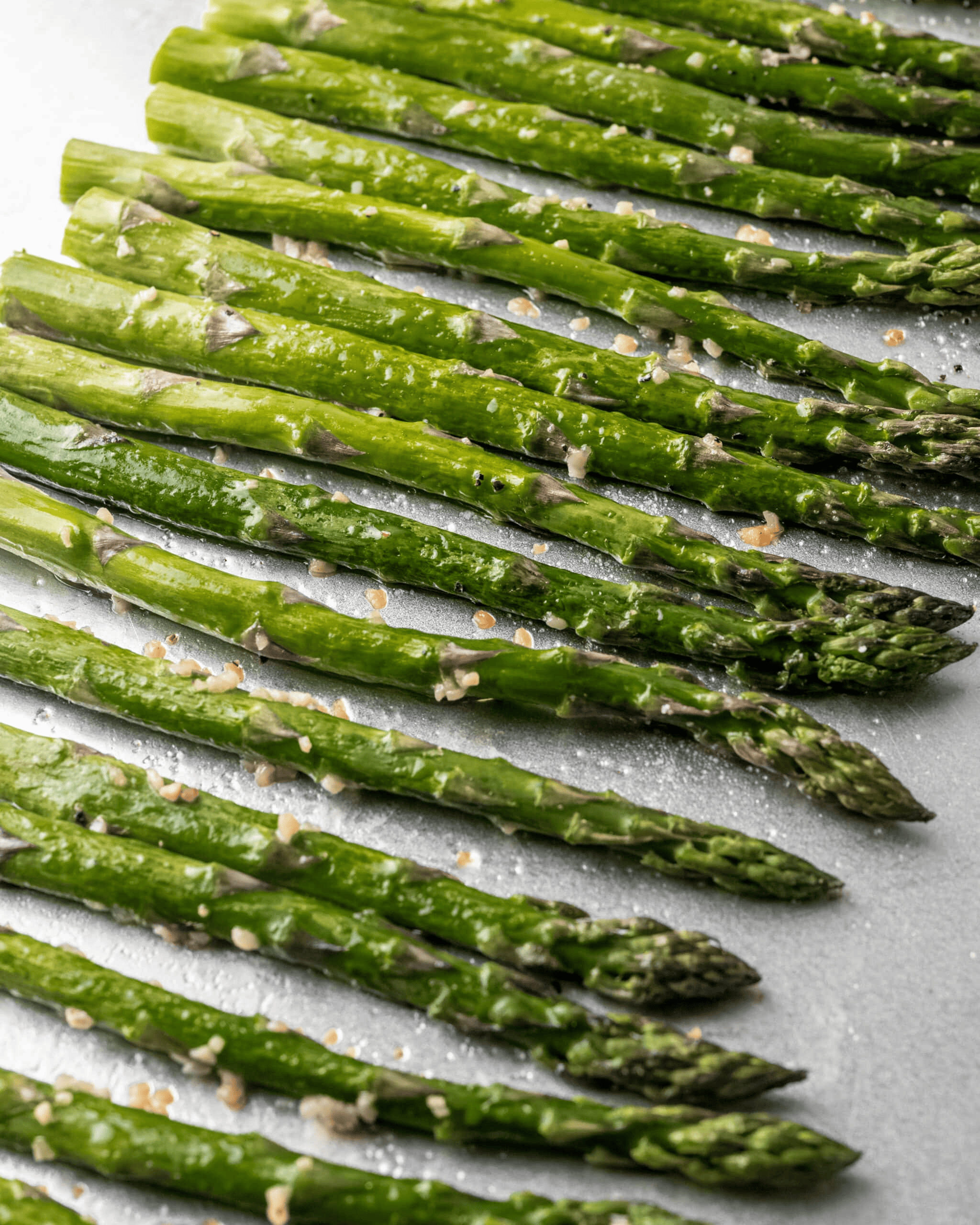 A photo of roasted asparagus on a baking sheet