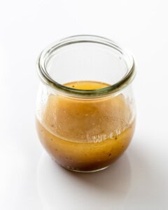 Lemon balsamic dressing in a glass jar.