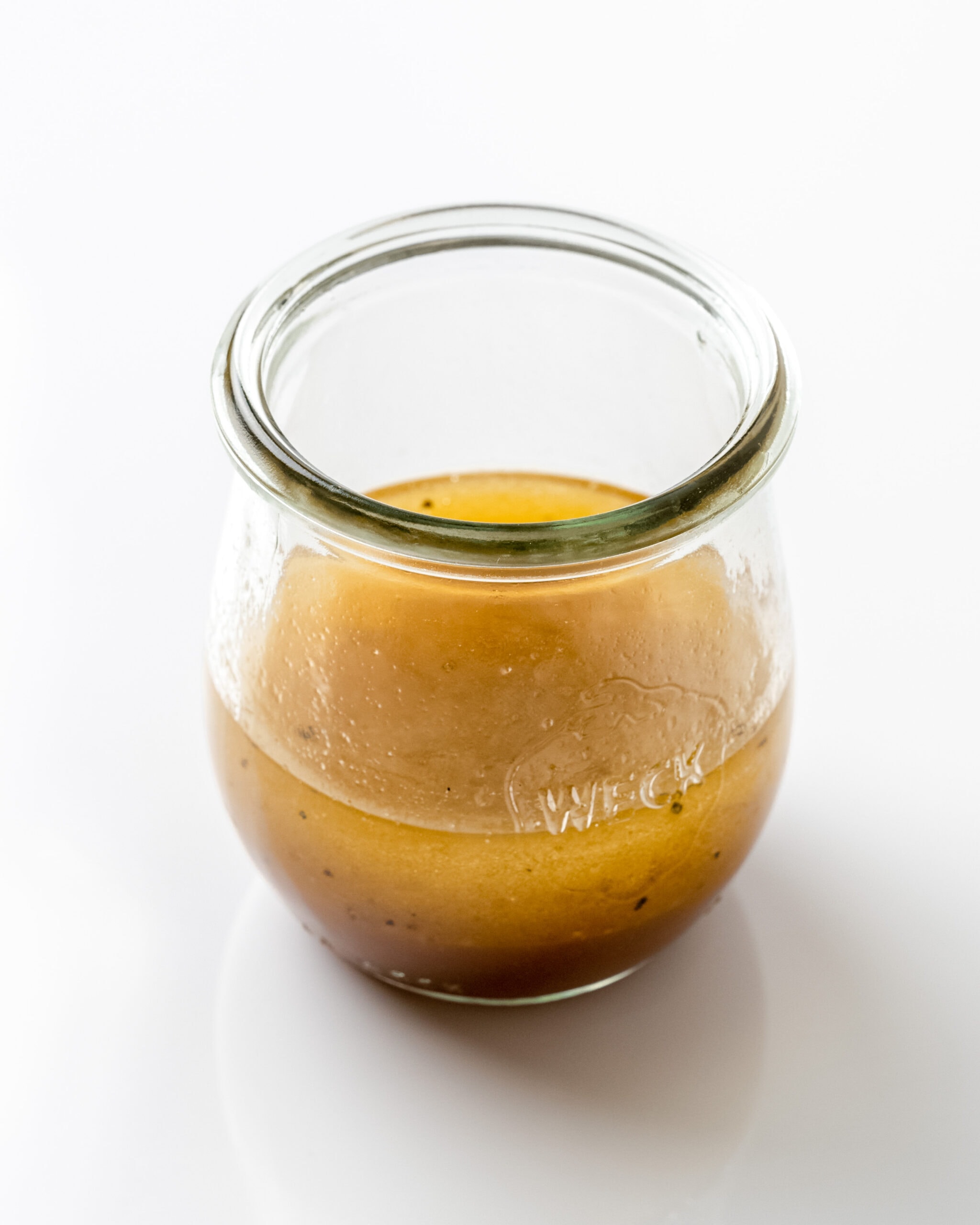 Lemon balsamic dressing in a glass jar.