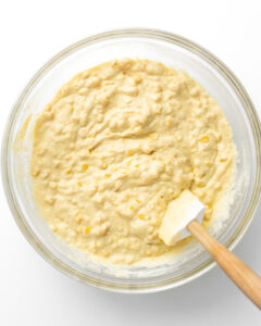 Wet and dry ingredients mixed together for corn casserole.