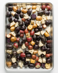 Rainbow potatoes on a baking sheet.