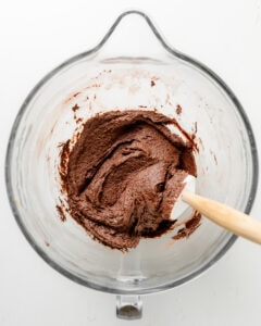 Mixing the wet and dry ingredients for cookies recipe.