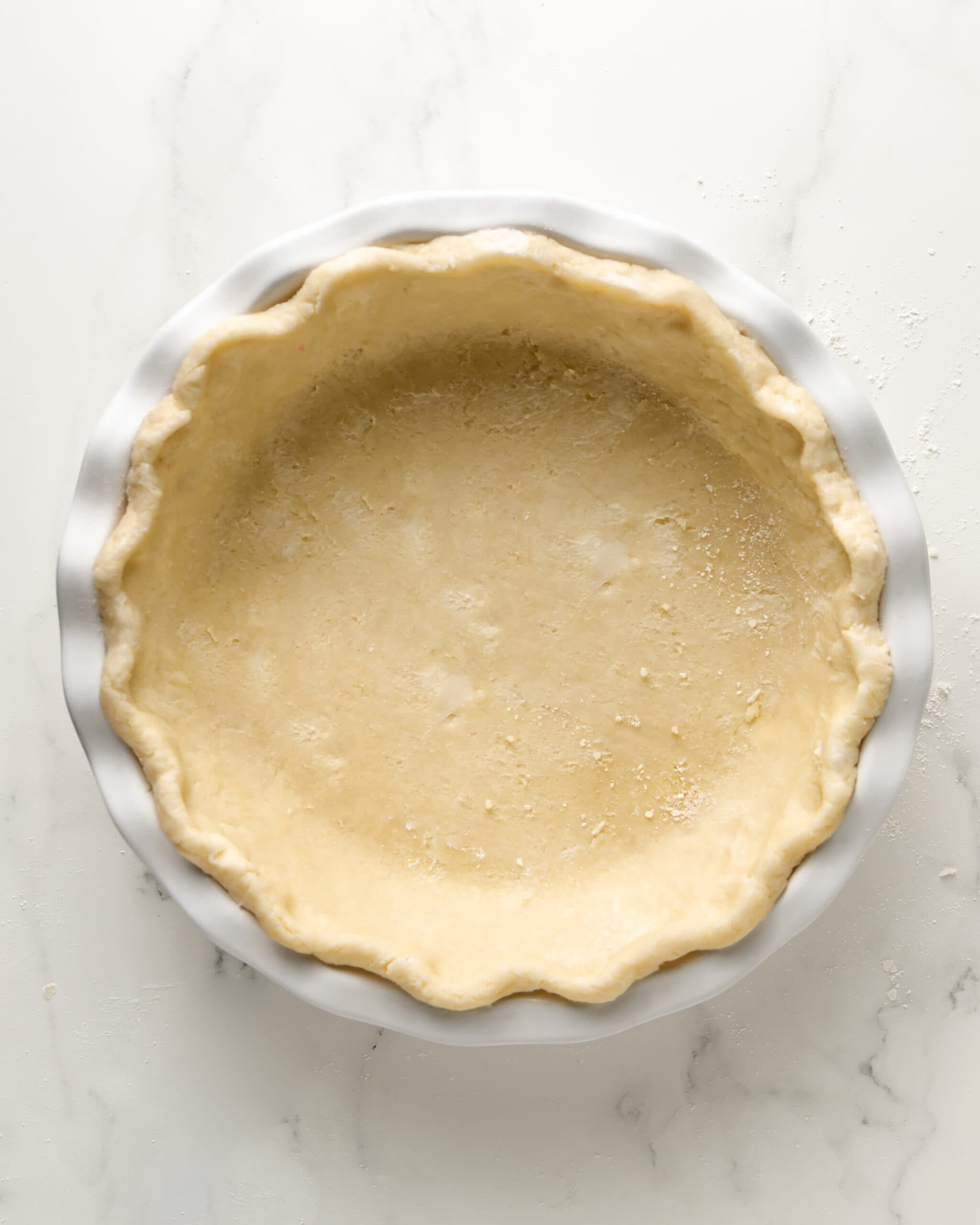 Gluten-free pie crust in a white ceramic pie dish. 