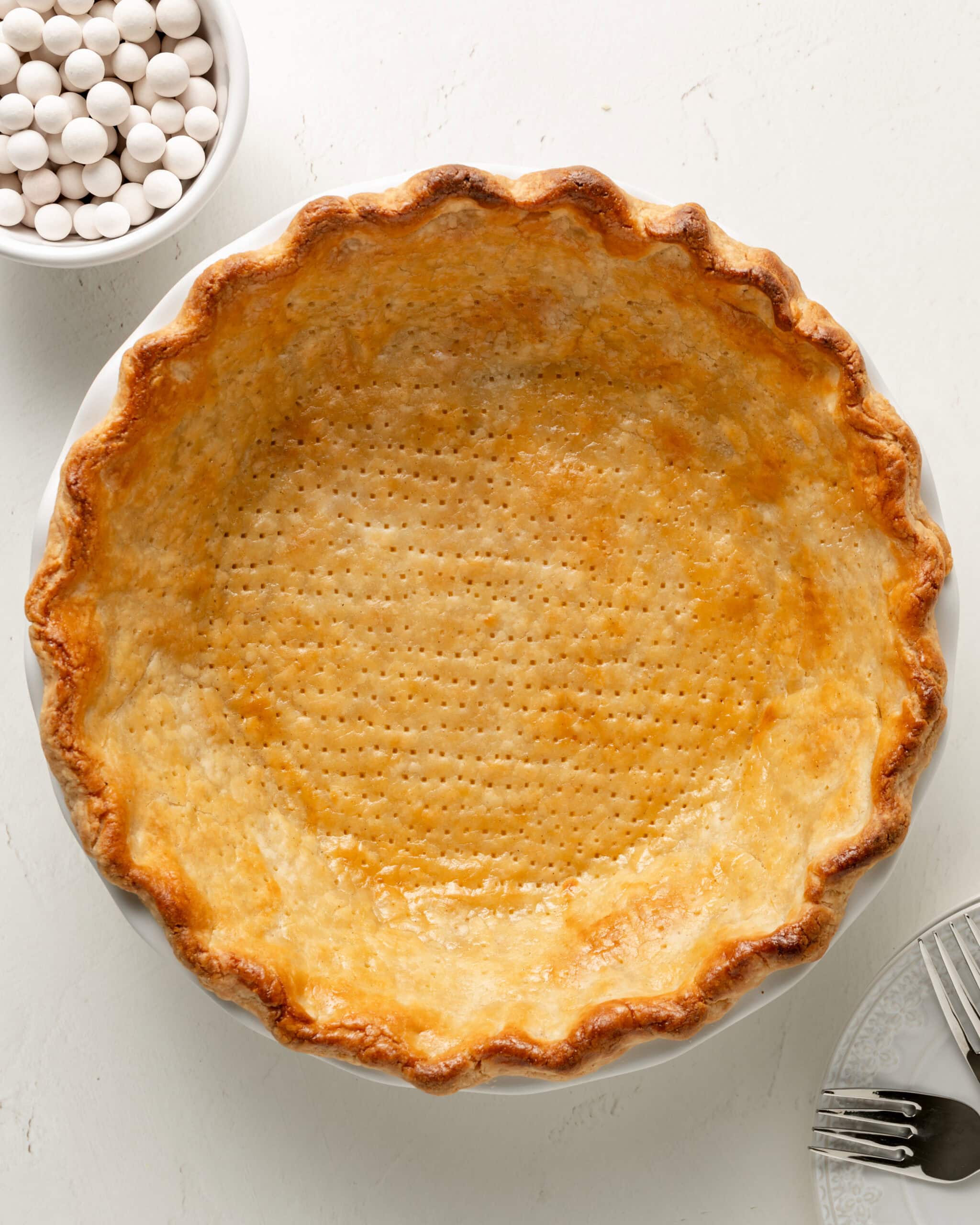Extra flaky Gluten-free pie crust in a white ceramic pie dish. 