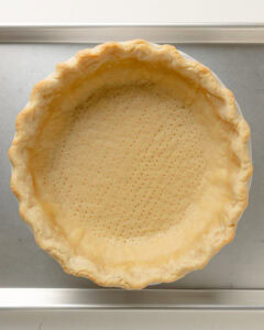 Par baked pie crust on baking sheet.