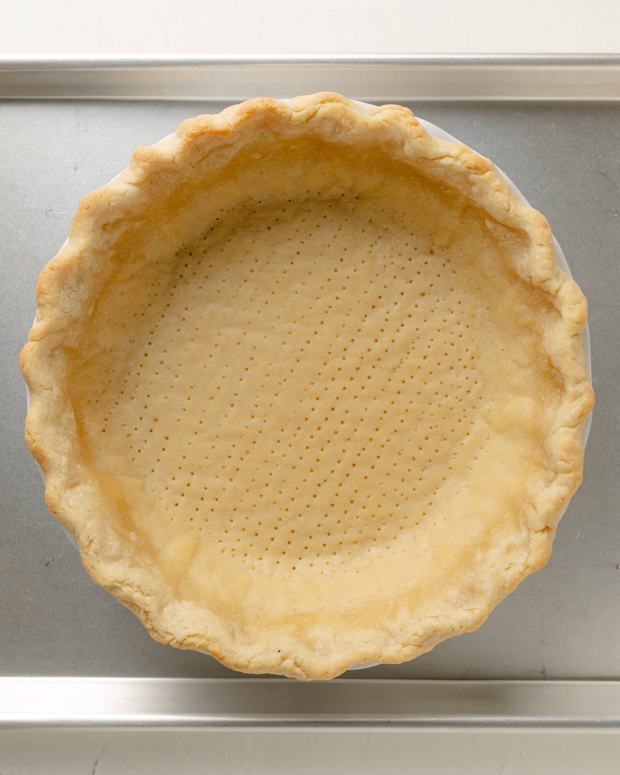 Par baked pie crust on baking sheet.