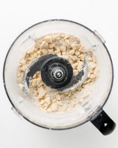 Adding sour cream to food processor for pie dough.