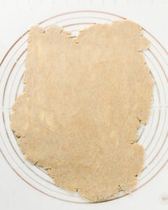 Rolled out pie crust on a silicone mat.