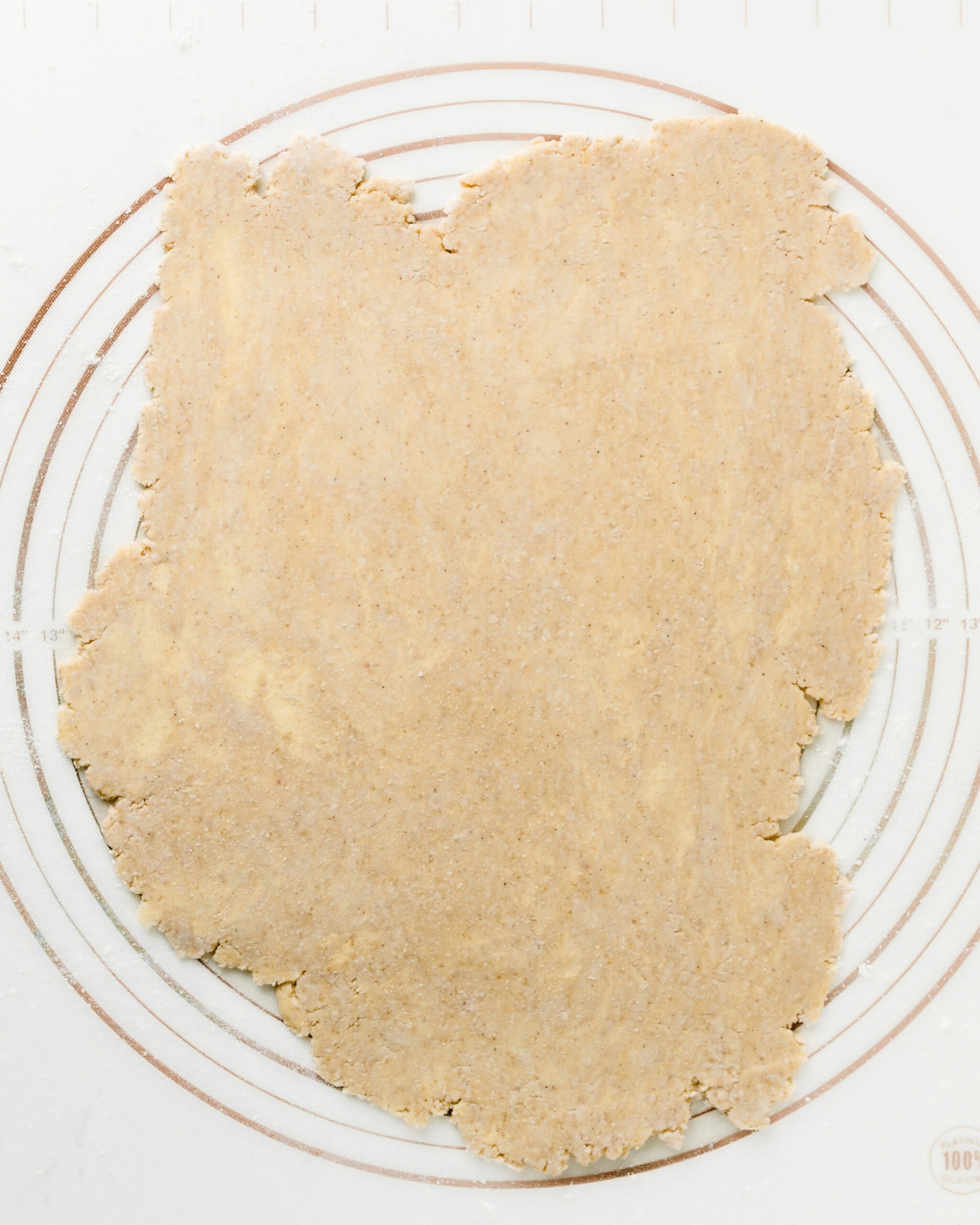 Rolled out pie crust on a silicone mat.