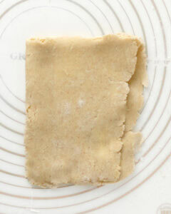 Folding a pie crust in half for lamination.