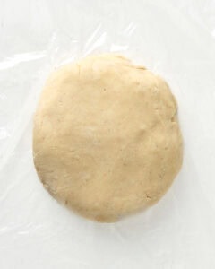 shaping the pie dough into a 1 inch disk.