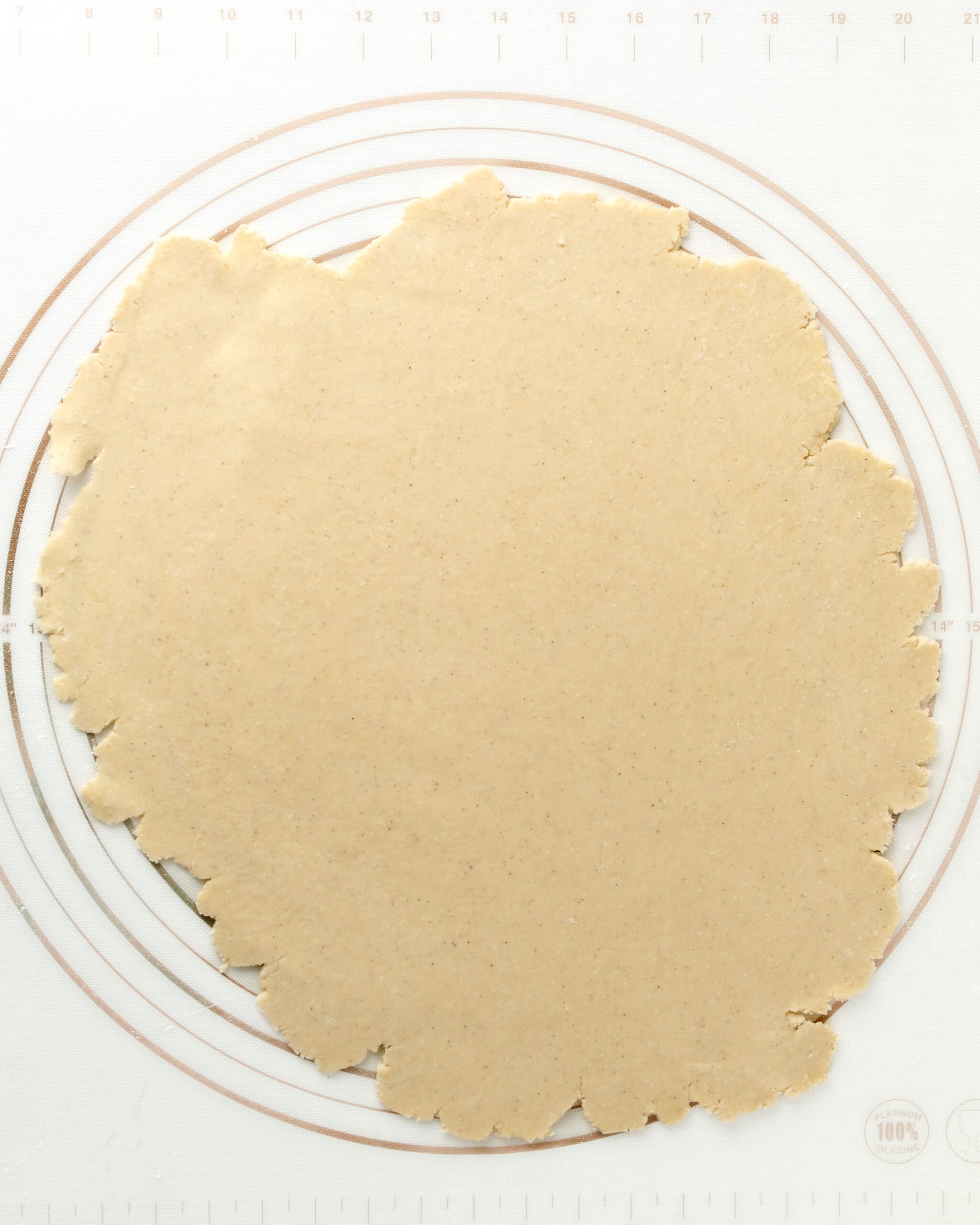 Rolling out the pie dough into a circle.