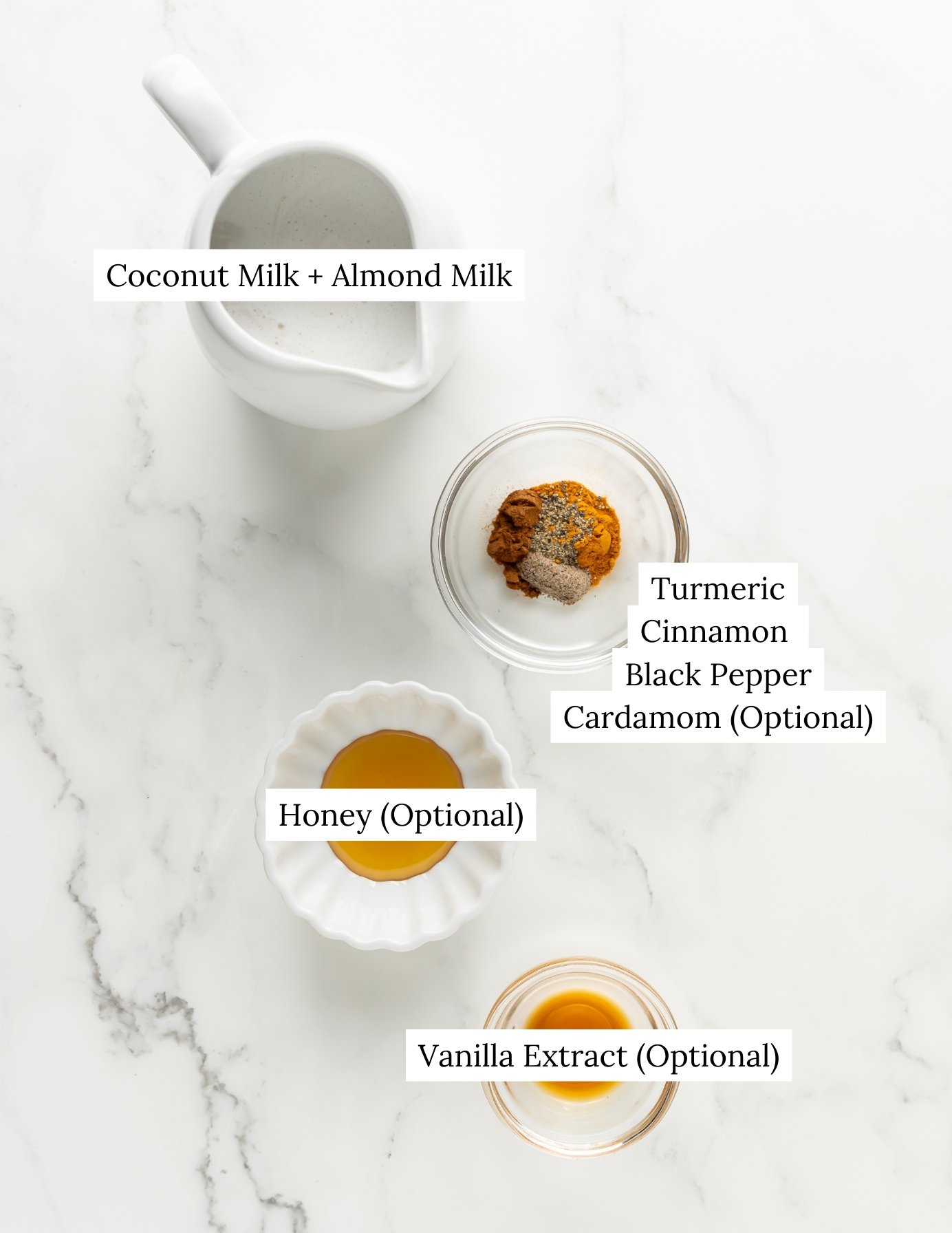 Ingredient shot of coconut milk, almond milk, spices, honey, and vanilla extract to make a golden milk latte.